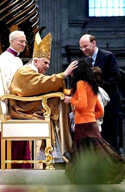 Benedict blessing a woman on the altar